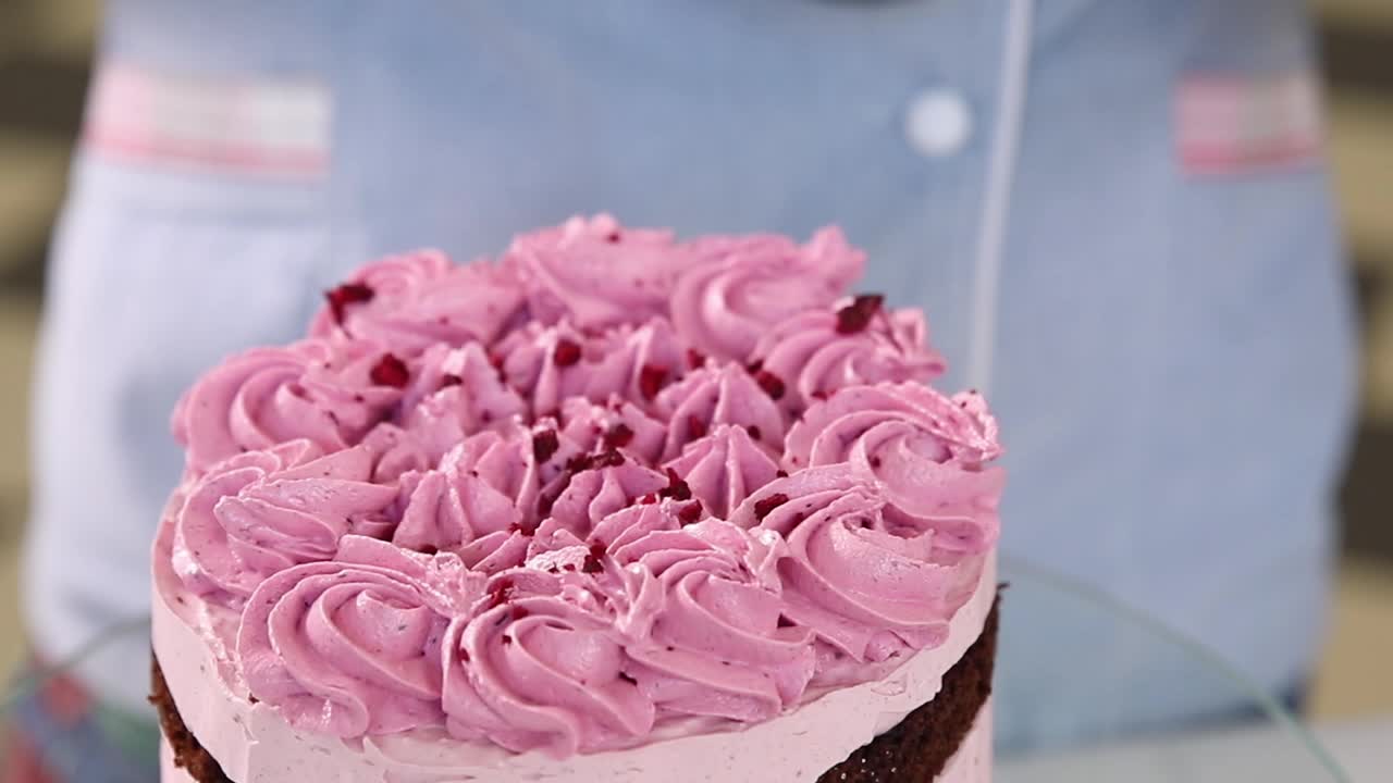Chef Decorating a Raspberry Pink Cake