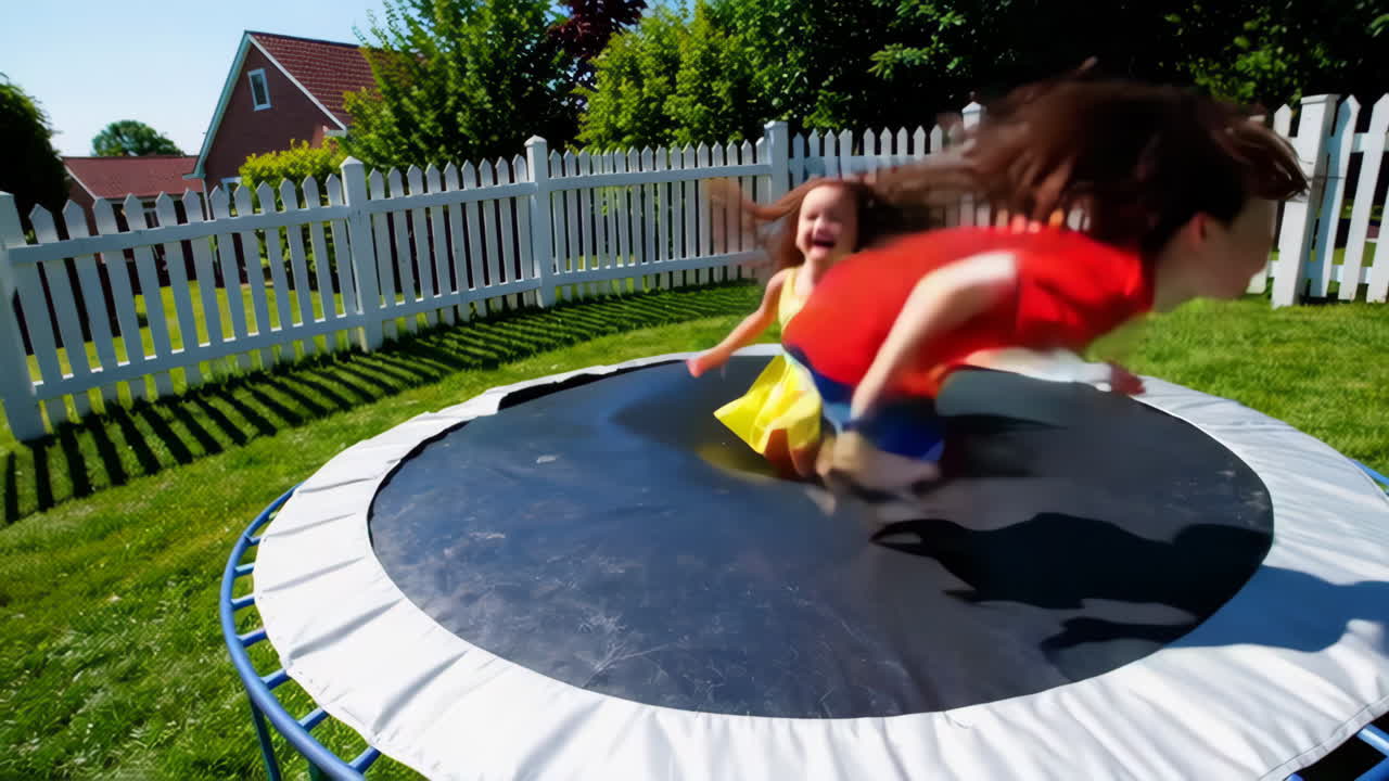 Joyful Kids Jumping on a Trampoline in a Sunny Backyard