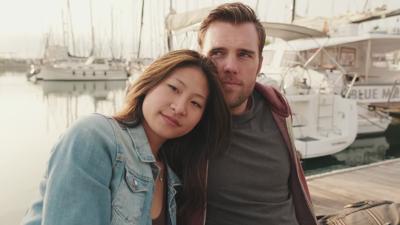 Couple at a harbor with boats