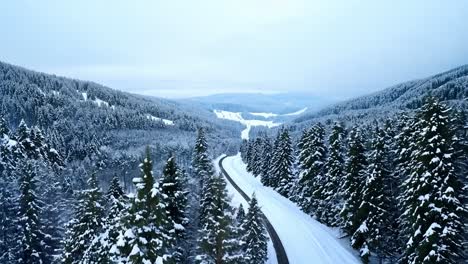 aerial view of a snowy road in the mountains