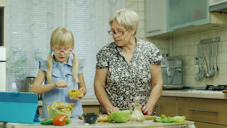 A-6-Year-Old-Girl-In-Pink-Glasses-Prepares-A-Salad-In-The-Kitchen