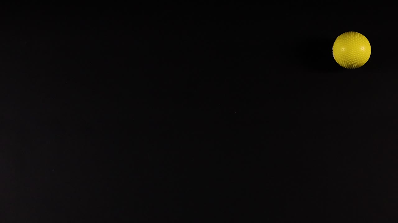 Yellow balls moving across a black grid