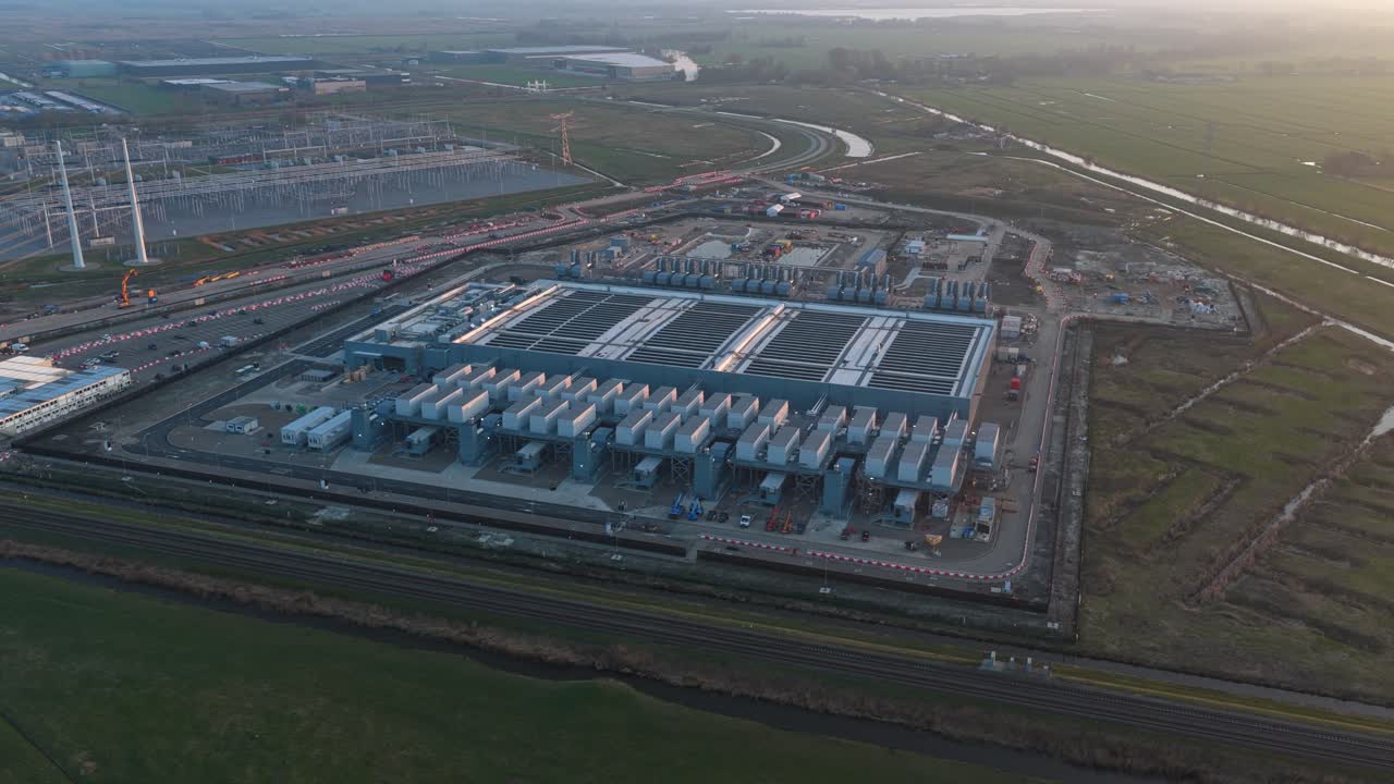 Expansive aerial perspective of a modern hyperscale data center during its construction phase, highlighting advanced infrastructure and technology