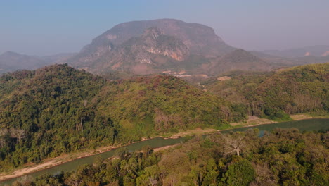 aerial view of mountainous landscape with river and forest
