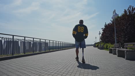 man with prosthetic leg walking in a park