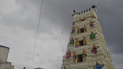 ramalayam temple gopuram with loud speakers and rainy clouds at dullapally, hyderabad, telangana, india. day time, stable shot, low angle shot, 4k