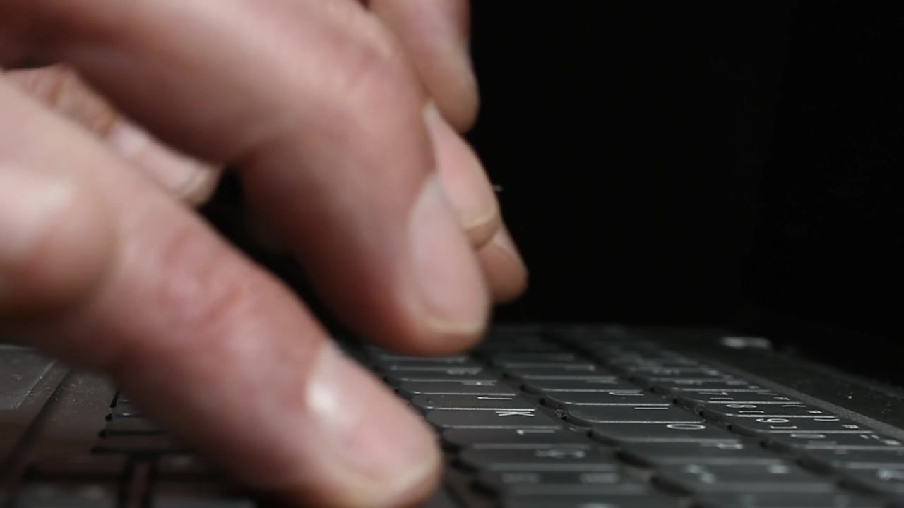 Typing on Computer on Black Background