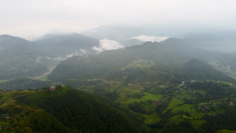 panoramic aerial overview of ridgeline overlooking winding road between valleys in nepal