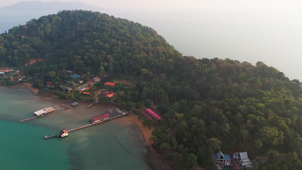 Birdseye view of Koh Chang island from above, turquoise water and bridges, buildings and foggy sky, copy space, background footage