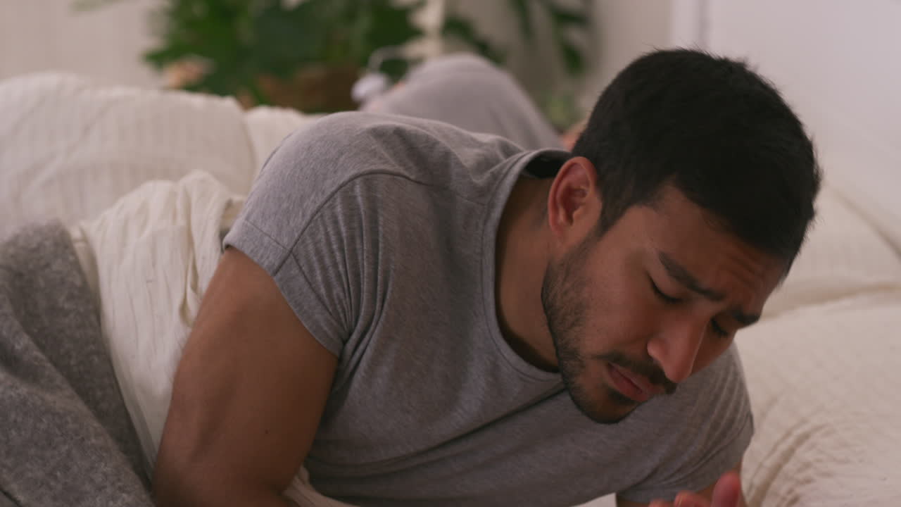 Man in bed looking sad