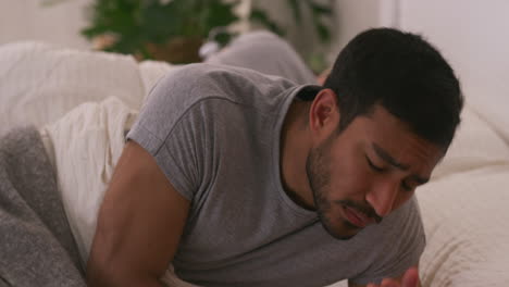 man in bed looking sad