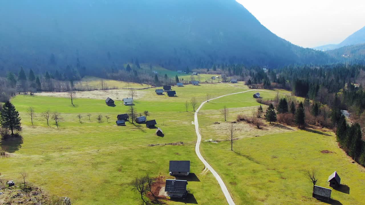 Aerial of a dreamy village in the middle of Triglav National Park on a misty day, Slovenia