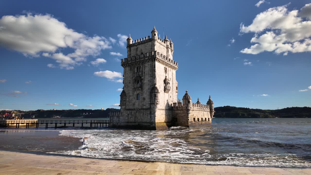 Slow Motion video of Belém Tower with waves in Lisbon,