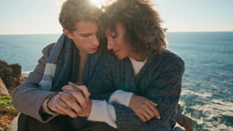 affectionate couple touching fingers bonding on sea beach closeup. romantic date