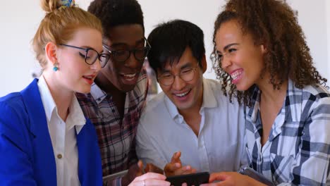 happy multi-ethnic business colleagues using mobile phone in modern office 4k