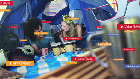 social media notifications animation over friends playing music in camping tent