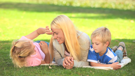 young woman talking with her two children