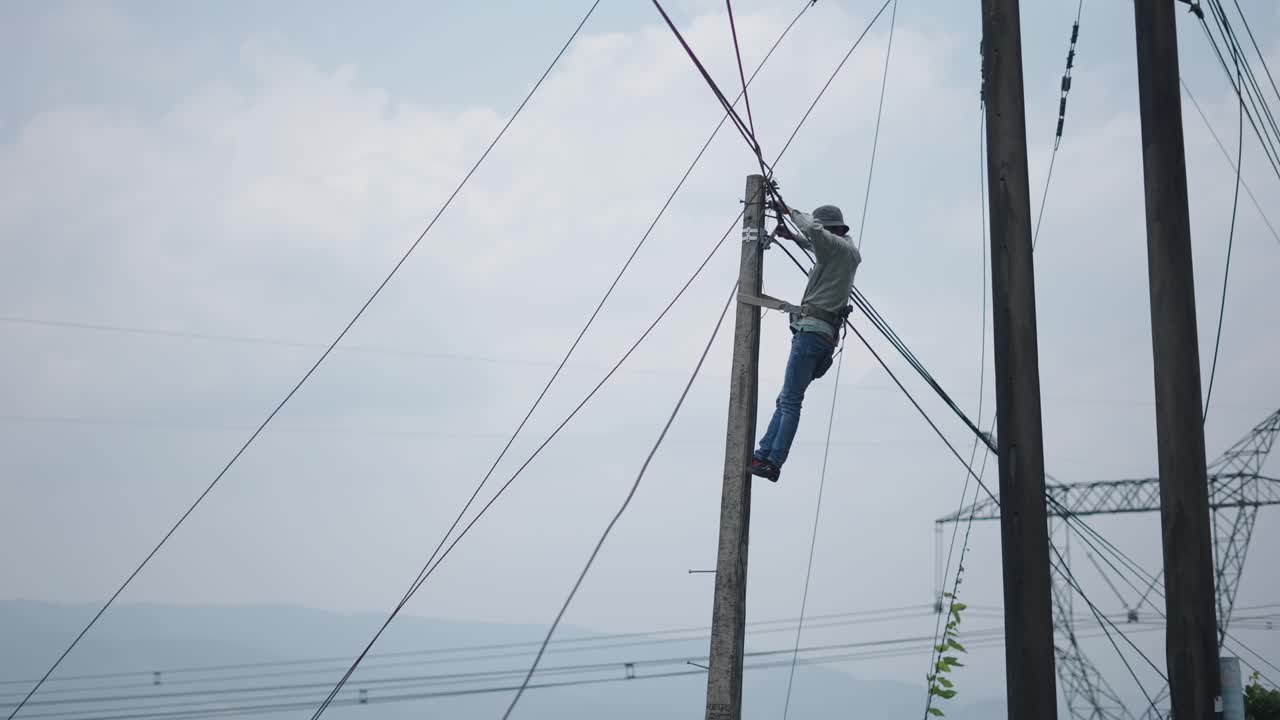 Worker repairing power lines