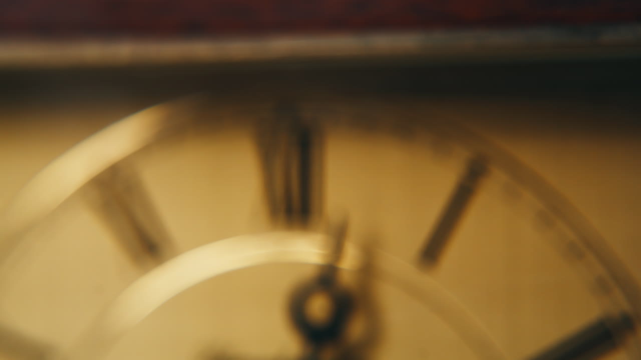 Retro hand showing time in evening light closeup. Macro view vintage clock measuring time