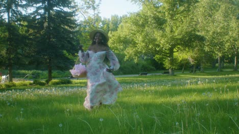 black woman on picnic in park running to smiling low angle