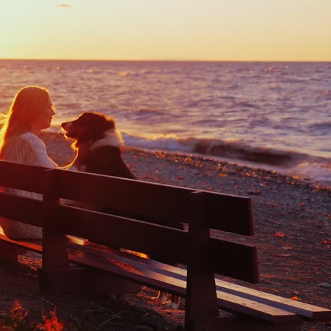 a woman rests with a dog on a bench