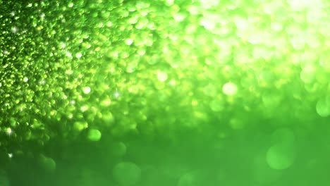 green animated bokeh background with glitter. video template.the concept of nature.