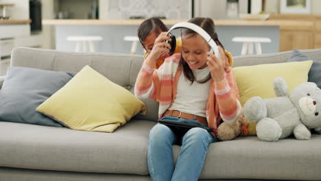 Tablet,-music-and-sister-children-on-a-sofa