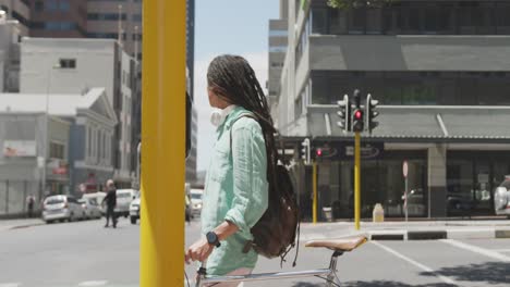 Mixed-race-man-walking-with-a-bike