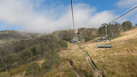 riding ski lift during summer season on australian ski slope