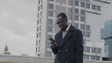 man using smartphone in city