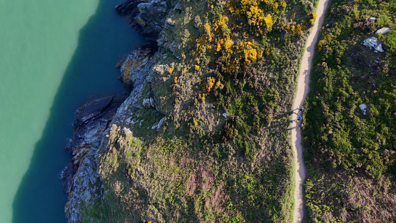 Hikers making their way along a cliff path in Howth, North Co Dublin, on a summers day