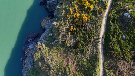 hikers making their way along a cliff path in howth, north co dublin, on a summers day