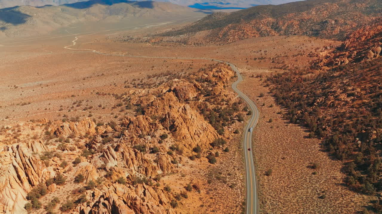 Aerial View of a Winding Road Through a Desert Mountain Landscape