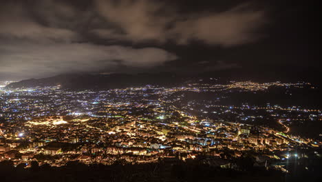 High-angle-shot-over-dark-Palermo-downtown-at-nigh-time-with-beautiful-night-city-lights-in-Sicily,-Italy-in-timelapse