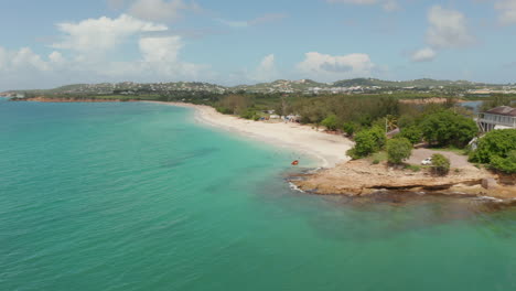 Aerial-low-angle-establishing-shot-of-caribbean-coast-in-Antigua-and-Bermuda