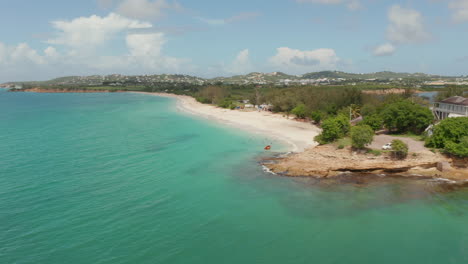 aerial low angle establishing shot of caribbean coast in antigua and bermuda