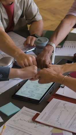 business team's fist bump for unity and success