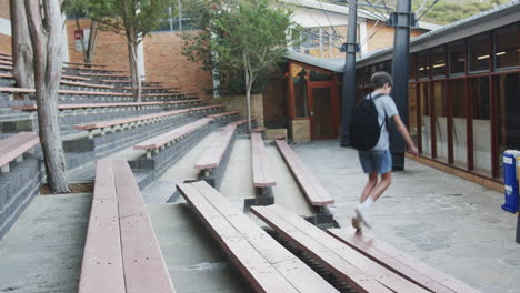 running through school courtyard, child enjoying outdoor activity after school, copy space