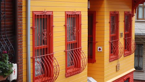 colorful historic house facade with red and yellow paint