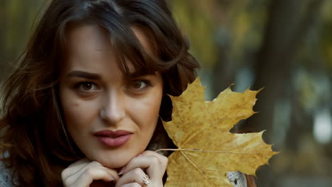 beautiful female dreaming in the autumn park. cheerful beautiful girl outdoors on beautiful fall day
