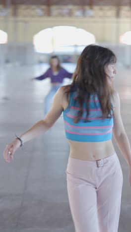 young women dancing in a spacious indoor setting