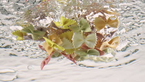 Farfalle-tricolore-pasta-in-boiling-water.-Shot-on-super-slow-motion-camera-1000-fps.