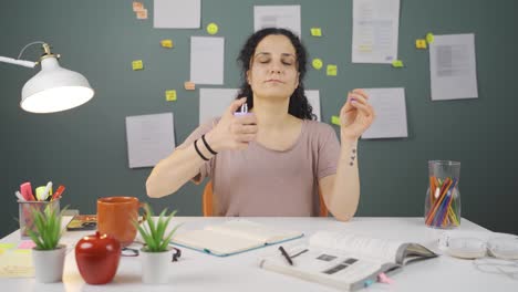 a female student spraying perfume.