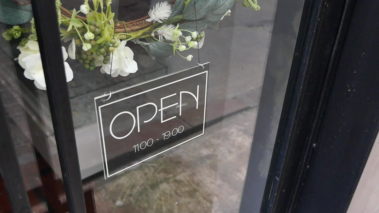 Open Sign with Business Hours on a Glass Door
