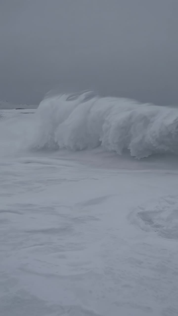 A serene winter landscape video with a wide-angle view, capturing vast snow-covered plains