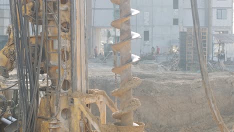 equipment for installing piles in ground, heavy machines for driving pillars work in laying the foundation building. construction aerial view height. construction site drilling pile foundation.