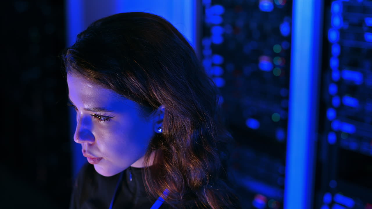 Woman programming in a server room