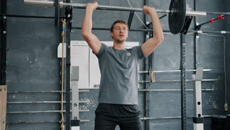 man performing shoulder press in a gym