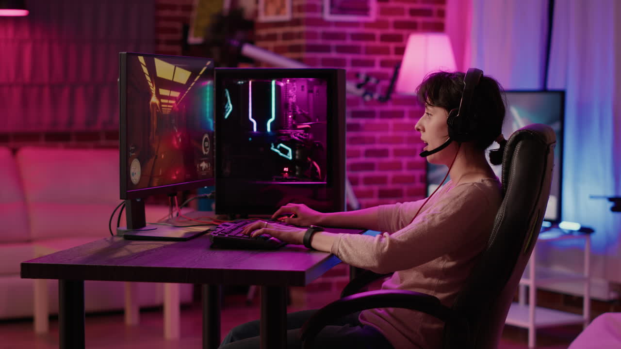 Handheld shot of gamer girl playing online action game celebrating after winning in first person shooter
