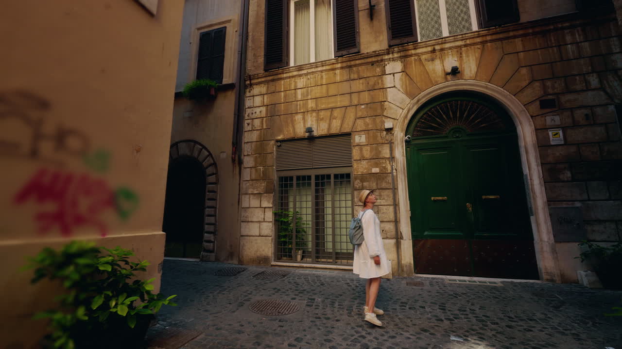 Woman walking through a narrow European alleyway
